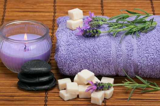 spa scene with lavender, oilve oil soap pieces, healing pebbles, and aromatic candle