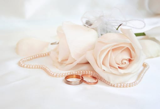 Wedding rings and roses as wedding background 