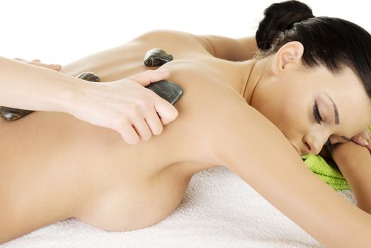 Beauty woman relaxing in spa. Stone massage.