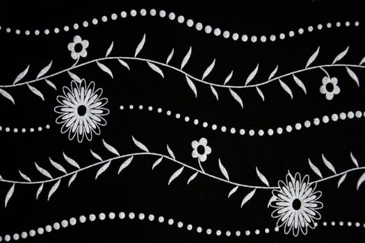Black fabric with white flower pattern can use as background 