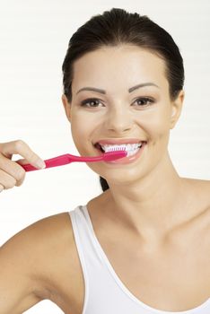 Woman with great teeth holding tooth brush