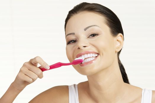 Woman with great teeth holding tooth brush