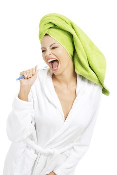 Happy attractive woman singing to tooth brush, isolated on white