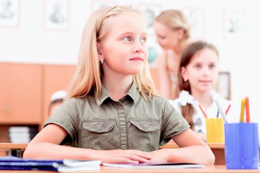 portrait of students in the classroom, sit at school desks