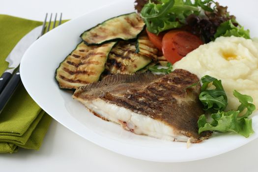 fried fish with vegetables and salad