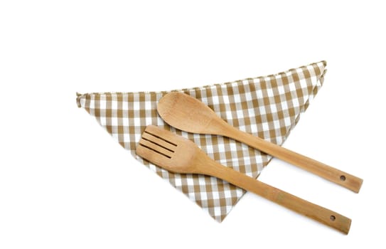 Wooden cooking utensils and napkin isolated on white