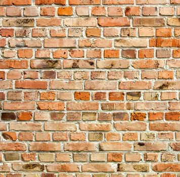 Old weathered red brick wall as background