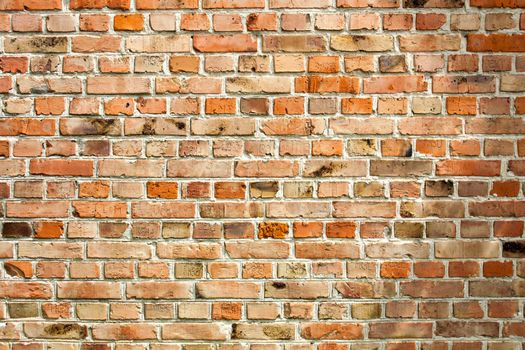 Old weathered red brick wall as background