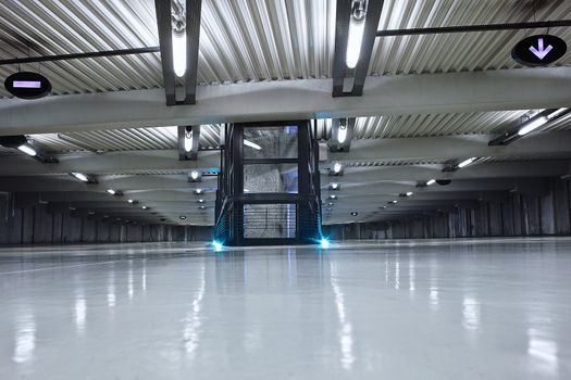 underground parking with neon light and no car