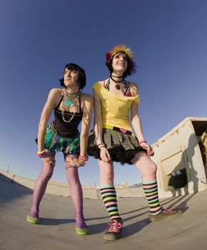 Fisheye shot of girls in brightly colored clothing on a roof