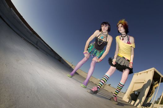 Fisheye shot of girls in brightly colored clothing on a roof