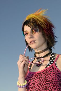 Close-up of a young punk woman with sunglasses