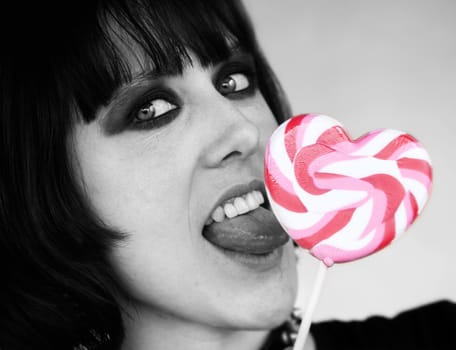 Close-up of an Alternative Girl with a Heart Lollipop