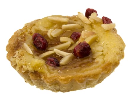 pear tartlette with sliced almonds and cherries on top, isolataed on white
