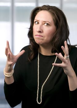 Frustrated Hispanic Woman Wearing Pearls Flexing Her Hands