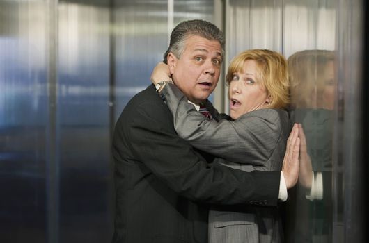 Couple caught in an embrace in a corporate office