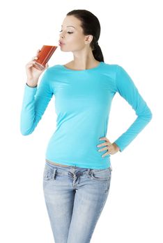 Happy smiling woman drinking tomato juice, isolated on white