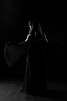 Young girl dancer in a darkness befor start
