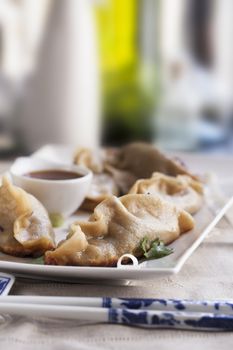 Potstickers appetizer with orange soy sauce.