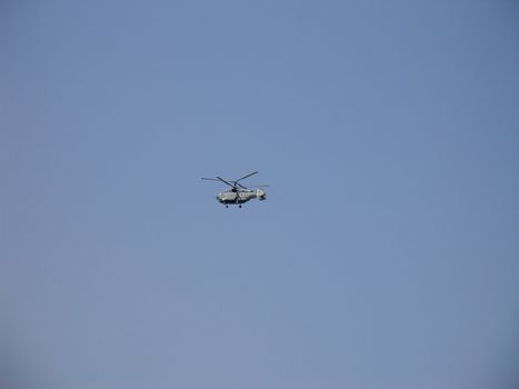 Russian helicopter flies in the blue sky