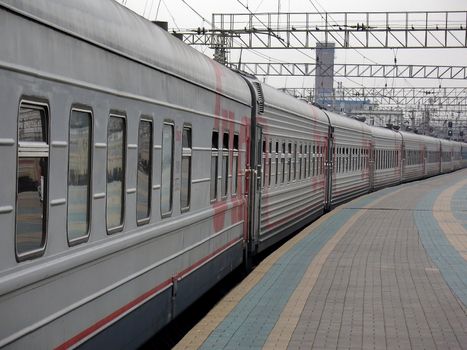 Rapid locomotive train with passengers at the station