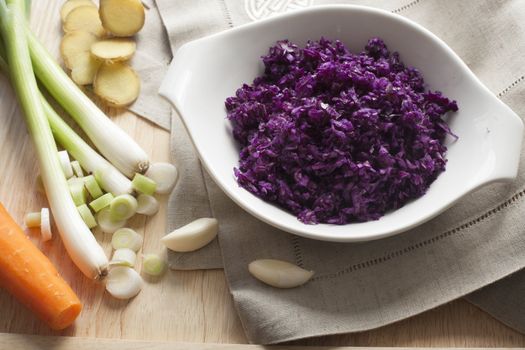 Grated red cabbage, green onions, carrots, garlic and ginger for vegetarian pot stickers