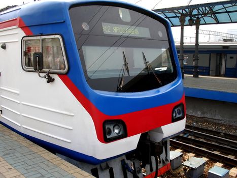 Rapid locomotive train with passengers at the station