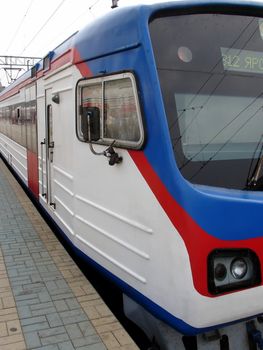 Rapid locomotive train with passengers at the station