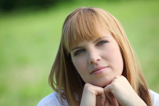 red-haired woman in green setting