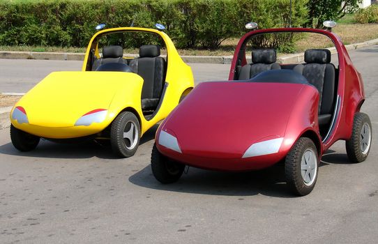Pair of red and yellow child cars