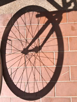 bike wheel shadow on floor tiles