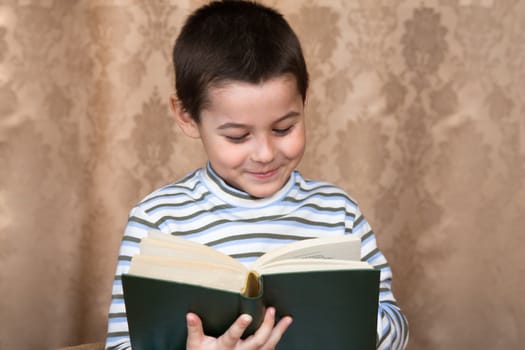 The boy reads the thick book