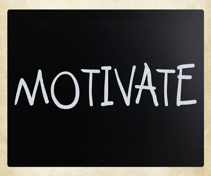 "Motivate" handwritten with white chalk on a blackboard