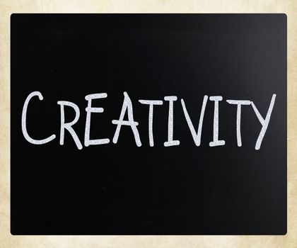 The word "Creativity" handwritten with white chalk on a blackboard