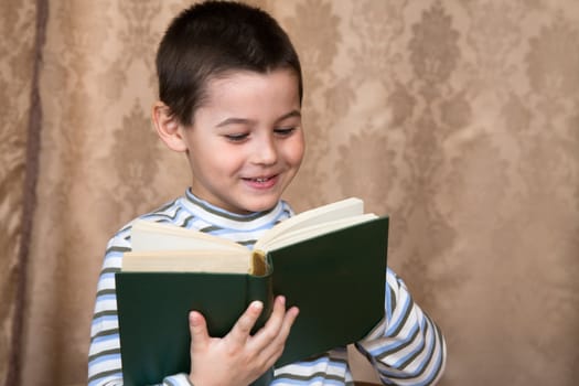 The boy reads the thick book