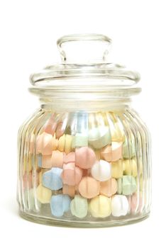 A variety of tasty candies in cliche candy jar.