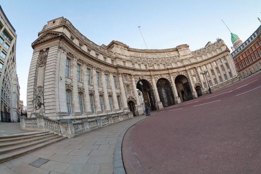 Admiralty Arch in London, England, United Kingdom. Shot taken fisheye wide angle lens, which highlights the curvilinear architectural forms and round the square in front