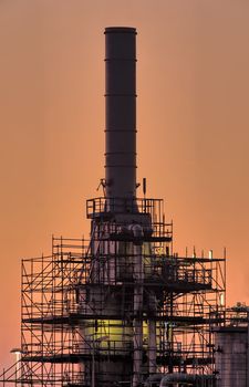 Industrial chimney under maintenance and repair in beautiful early morning light
