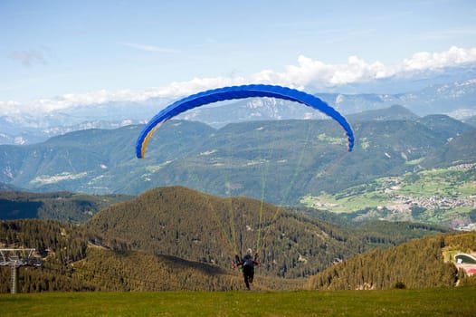 Starting a Paragliding in the Alps of Trentino