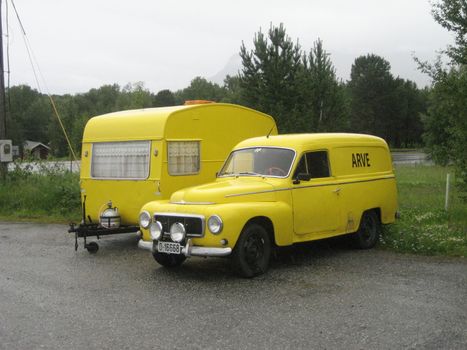 Volvo Duett and caravan, both in bright yellow.