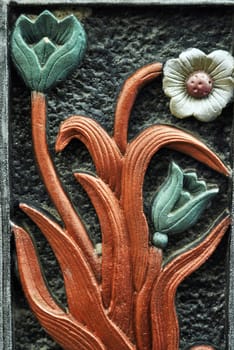 flower-shaped sculpture on the concrete wall