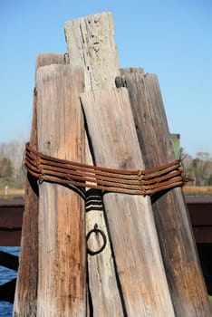 Old pylons along the dock ready for a boat to tie up.