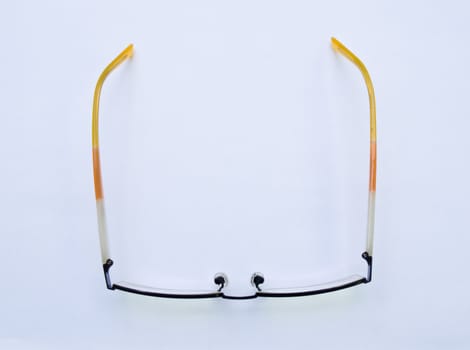 Yellow glasses isolated on white background topview