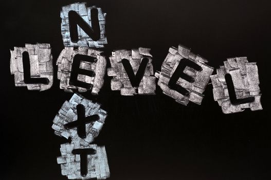Crossword of Next Level written in chalk on a blackboard