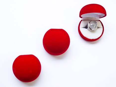 Opened round red jewelry boxes isolated on white background