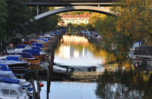 Boats in a canal an early morning in Stockholm, Sweden.