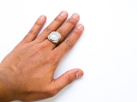 A guy hand with white jade ring on his finger isolated on white background