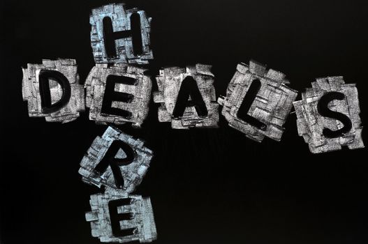 Crossword of Deals Here written in chalk on a blackboard