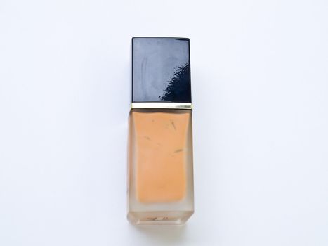 Bottle of cosmetic liquid foundation on white background.