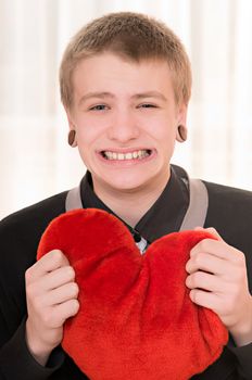 frustrated teenager  with a plush heart in hand